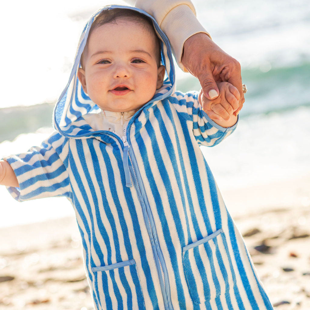 baby boy wearing blue and white striped beach poncho